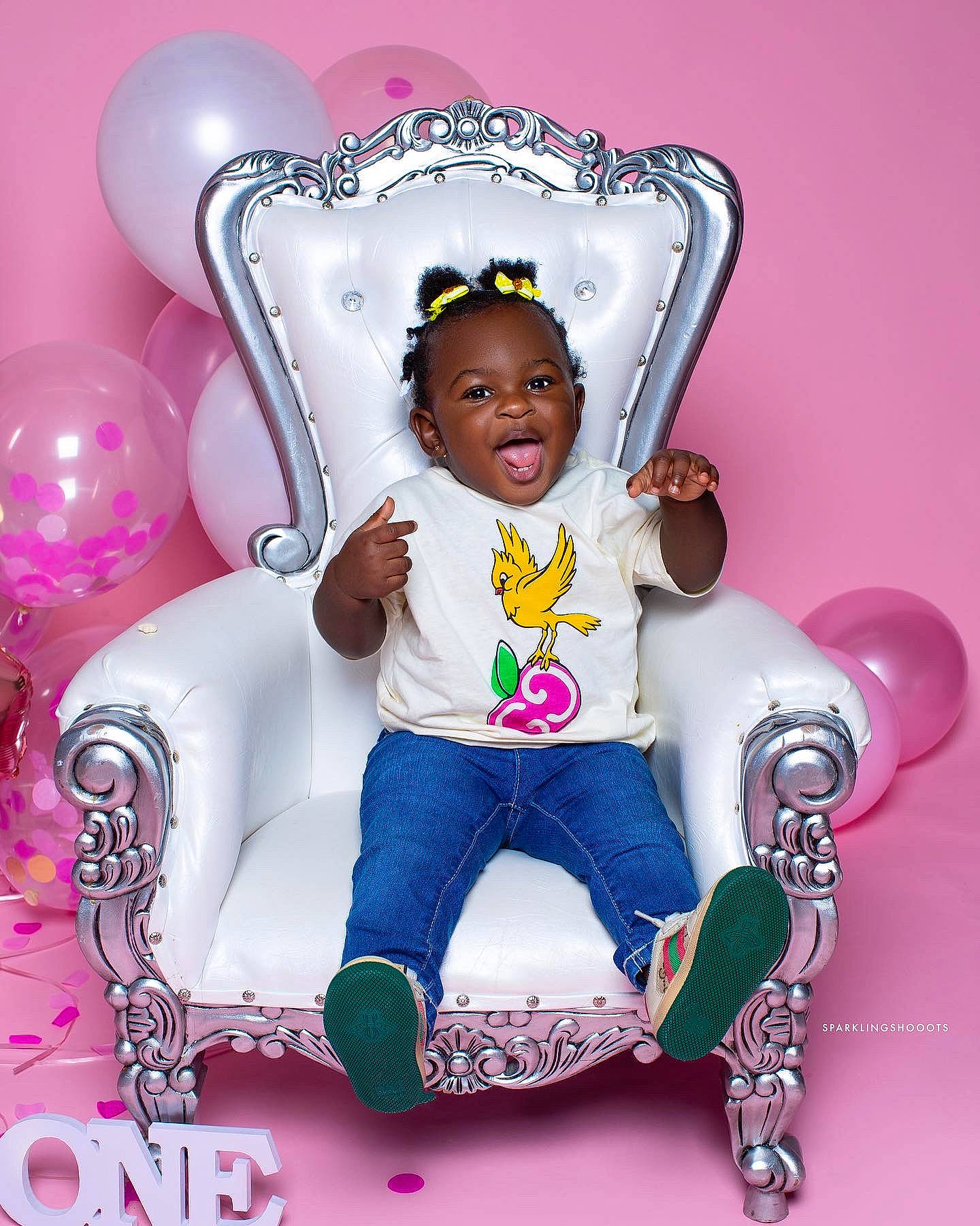 Devyn is registered to the contest to win money with this photo: baby, baby_products, baby_toddler_clothing, balloon, chair, cheek, child, event, fashion_accessory, font, fun, happy, icing, magenta, party_supply, person, pink, purple, sitting, smile