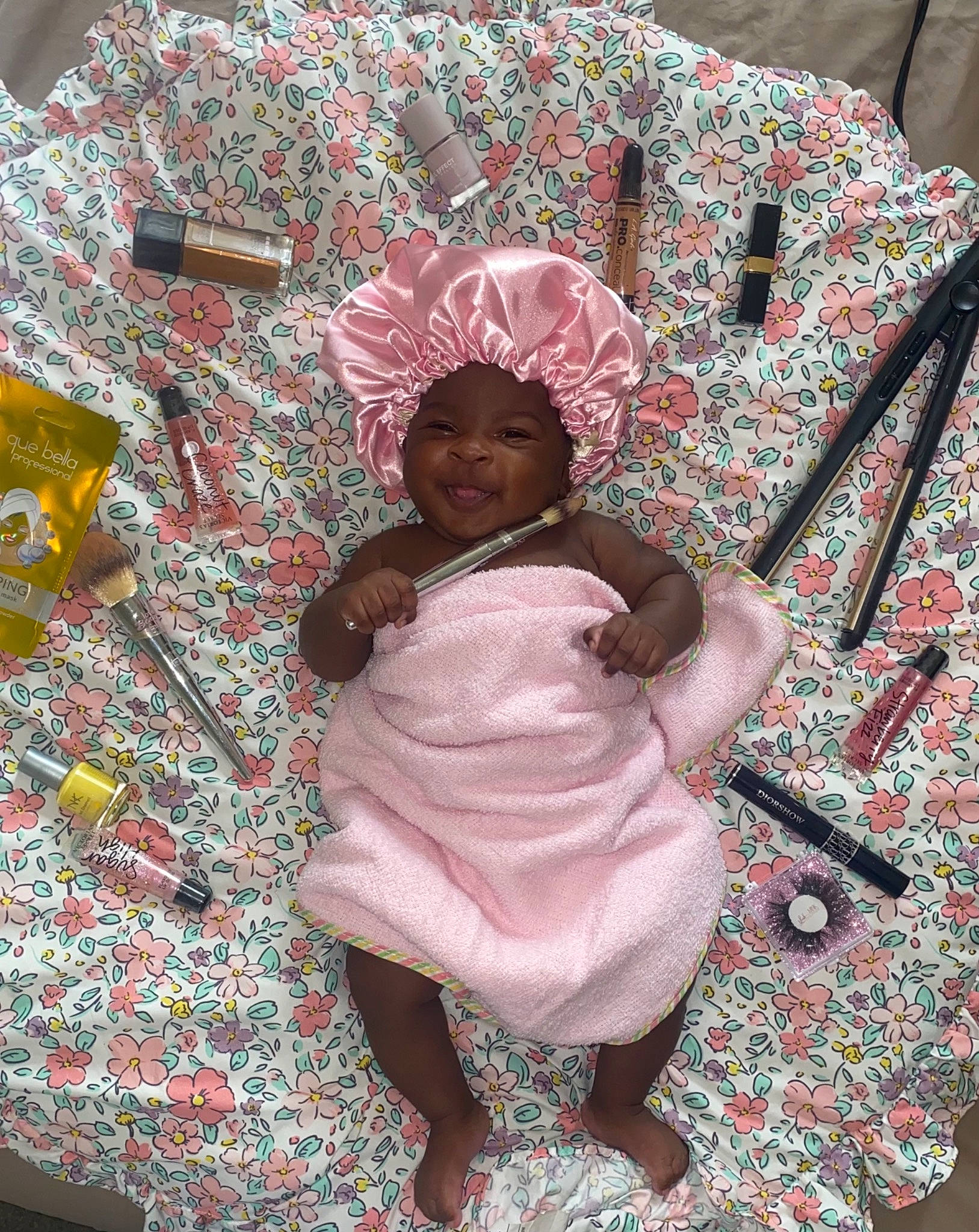 Devyn is registered to the contest to win money with this photo: art, baby, child, comfort, event, flesh, fun, happy, headwear, joy, linens, magenta, pattern, person, pink, room, sitting, sleeve, smile, t_shirt
