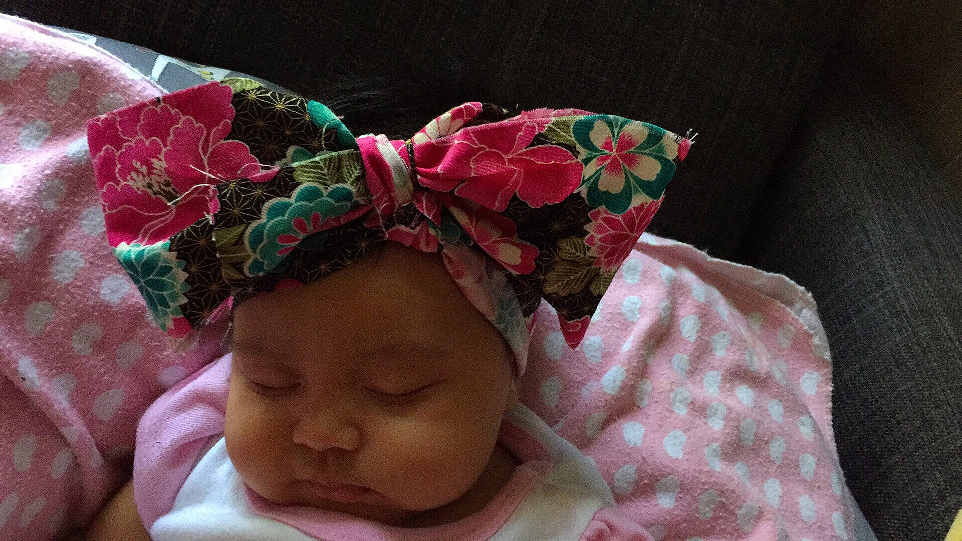 Everleigh is registered to the contest to win money with this photo: baby, cheek, child, ear, fashion_accessory, flower, hair_accessory, headband, headgear, headpiece, person, pink, plant, toddler