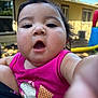 baby, child, face, pink_shirt, outdoor, backyard, curious, open_mouth, close_up, person, play_equipment, sunny, daylight, casual_clothing, infant, expression, skin, hair, window, house