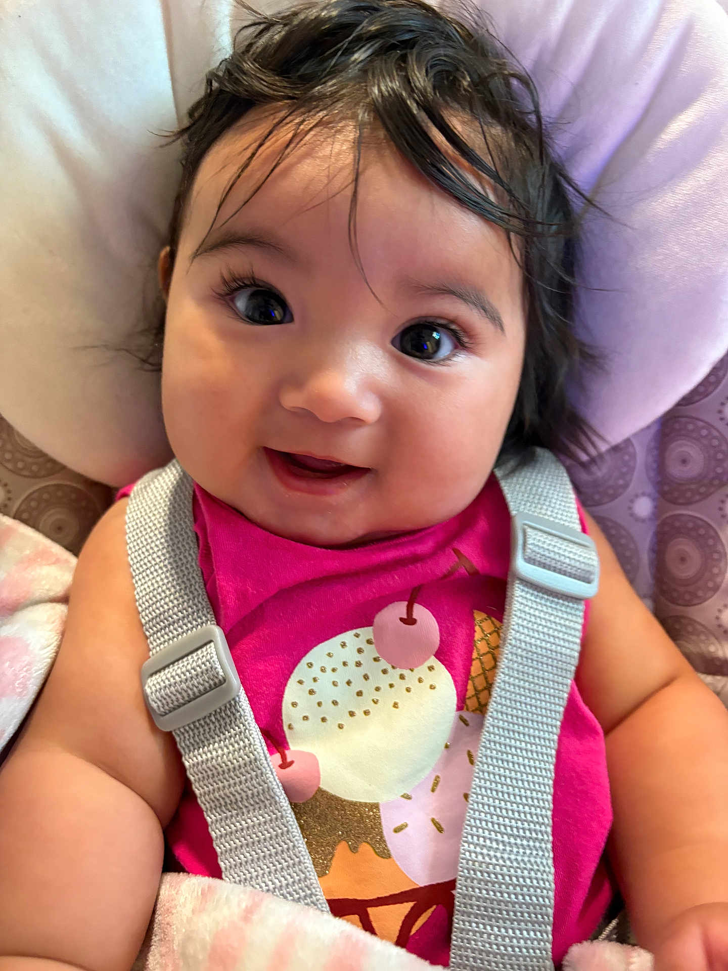 Helena joined the competition — help win amazing prizes! baby, child, smiling, face, hair, car_seat, seatbelt, pink_shirt, clothing, blanket, closeup, cute, infant, young_child, indoors, person, happy, skin, portrait, seat