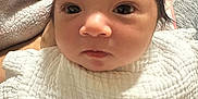 Helena joined the competition — help win amazing prizes! baby, infant, face, eyes, blanket, white_clothing, bottle, soft_texture, closeup, newborn, portrait, person, baby_bottle, hair, skin, indoors, resting, cute, child, young