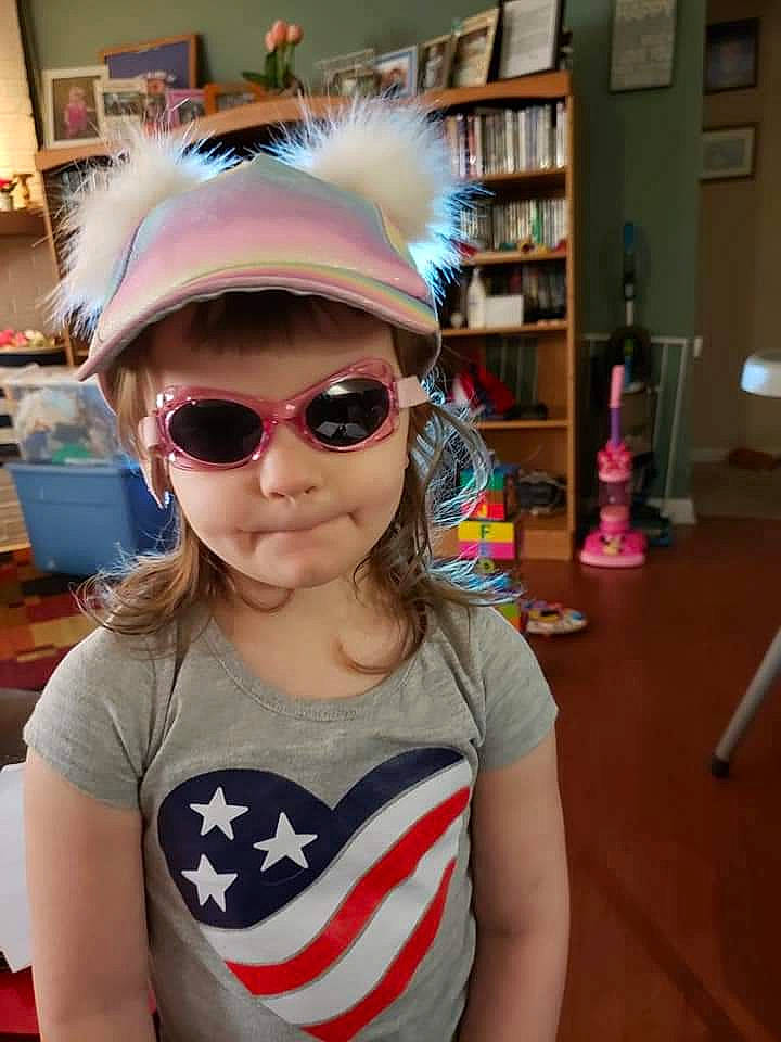 Lila is registered to the contest to win money with this photo: bookcase, cap, chin, cool, eyewear, facial_expression, fashion, glasses, goggles, hairstyle, happy, helmet, outerwear, person, personal_protective_equipment, selfie, sleeve, street_fashion, sunglasses, textile