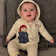 Enzo joined the competition — help win amazing prizes! baby, child, hoodie, sitting, blanket, cute, smiling, indoors, cozy, portrait, clothing, socks, face, young_child, happy, couch, soft_texture, infant, casual, comfortable