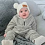 Enzo joined the competition — help win amazing prizes! baby, infant, child, smiling, hat, pom_poms, fluffy_clothing, socks, couch, blanket, soft_texture, indoor, comfortable, cute, happy, portrait, seated, cozy, warm_clothing, headwear