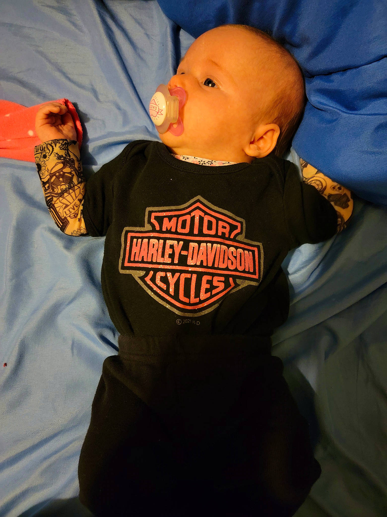 Haylee is registered to the contest to win money with this photo: baby, baby_toddler_clothing, carmine, cheek, child, finger, font, fun, hood, human_body, jacket, logo, long_sleeved_t_shirt, orange, person, sleeve, sportswear, t_shirt, thumb, toddler