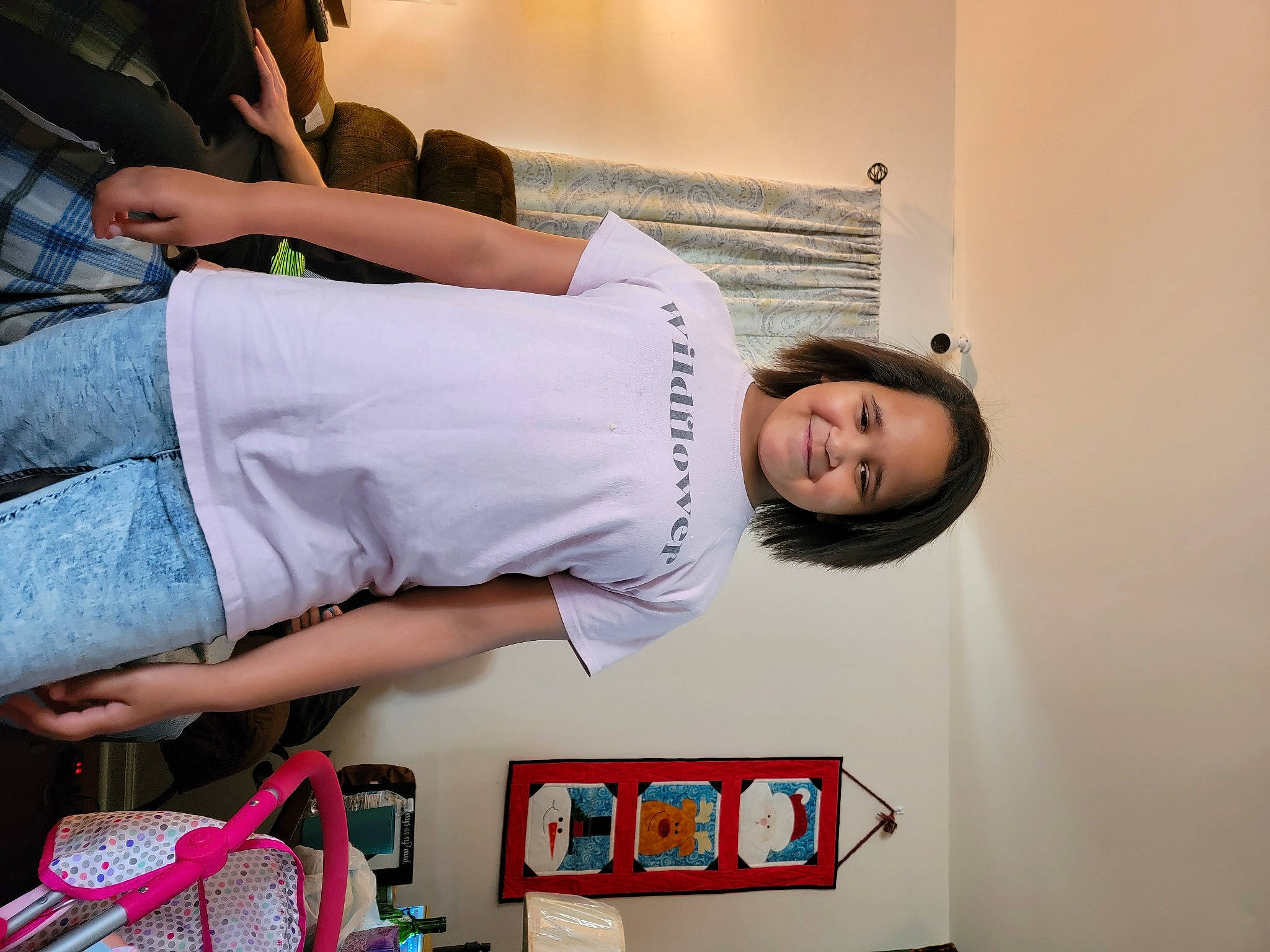 Athena is registered to the contest to win money with this photo: child, clothing, denim, elbow, eyewear, fashion_design, fun, happy, human_leg, jeans, joint, joy, luggage_and_bags, magenta, person, room, shoulder, smile, t_shirt, thigh