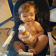 Lori joined the competition — help win amazing prizes! baby, toddler, child, high_chair, bottle, smile, bare_chest, hands, feet, hair, indoors, kitchen, floor, seat, feeding, playful, cute, sitting, expression, mess