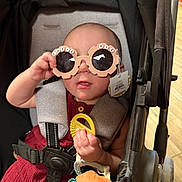 Raelynn Marie joined the competition — help win amazing prizes! baby, stroller, sunglasses, toy, child, cute, infant, seatbelt, playful, accessory, person, indoor, casual, clothing, hand, face, head, expression, comfort, colorful