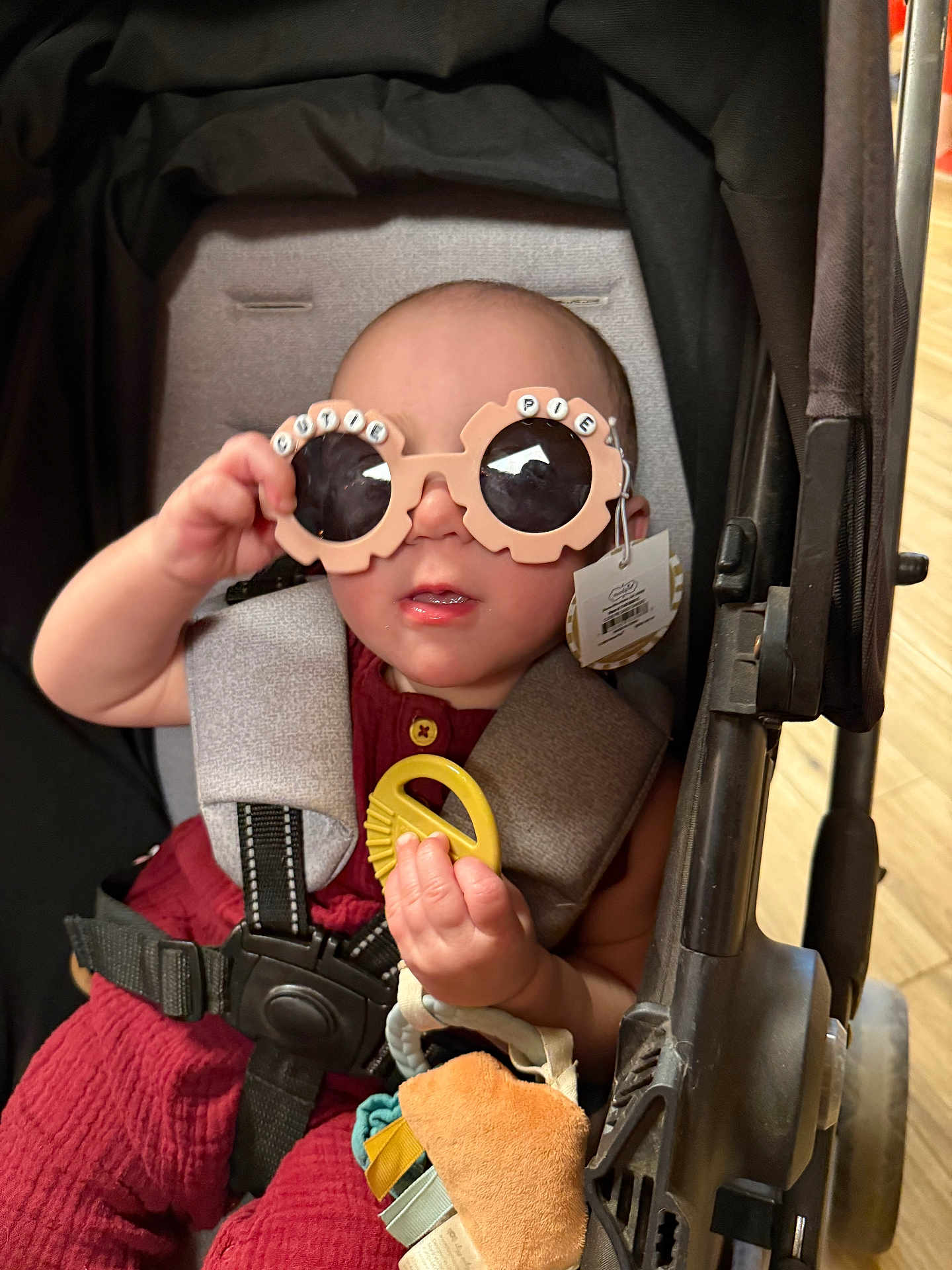 Raelynn Marie joined the competition — help win amazing prizes! baby, stroller, sunglasses, toy, child, cute, infant, seatbelt, playful, accessory, person, indoor, casual, clothing, hand, face, head, expression, comfort, colorful