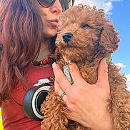 Choopy a rejoint le concours — aidez-le/la à gagner de superbes lots ! woman, dog, puppy, curly_hair, sunglasses, outdoor, sky, clouds, hand, holding, red_shirt, necklace, ring, sunlight, portrait, cute, pet, affection, calm, closeup