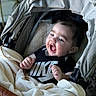 baby, infant, stroller, blanket, clothing, nike, happy, smiling, face, person, child, indoors, cute, hand, portrait, expression, cozy, soft, comfortable, babywearing