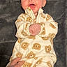 Iziah is registered to the contest to win money with this photo: baby, child, infant, smiling, onesie, bear_pattern, tattooed_hand, blanket, soft_texture, happy, portrait, cute, lying_down, cozy, clothing, person, indoor, young_child, expression, hands