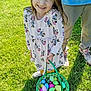 adult, basket, child, colorful, daylight, dress, easter_eggs, footwear, girl, green_grass, happy, holiday, legs, minnie_mouse, outdoor, playful, smiling, spring, sunny, toy