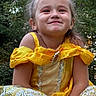 Georgia Deann is registered to the contest to win money with this photo: child, girl, princess, portrait, smiling, happy, outdoor, forest, trees, yellow_dress, costume, sparkles, jewelry, hair_bow, blonde_hair, sitting, close_up, face, celebration, photography