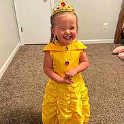 Georgia Deann joined the competition — help win amazing prizes! child, girl, princess, yellow_dress, crown, smiling, jewelry, necklace, earrings, carpet, indoor, happy, cute, costume, dress_up, standing, room, door, wall, playful
