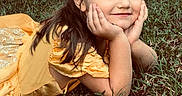 Georgia Deann is registered to the contest to win money with this photo: child, girl, smiling, portrait, outdoor, grass, garden, yellow_dress, hair_bow, long_hair, brown_hair, sitting, lying_down, hands_on_cheeks, face, happy, sunlight, nature, grass_lawn, photography