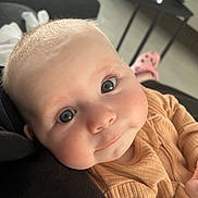 Blair joined the competition — help win amazing prizes! baby, child, face, blue_eyes, close_up, infant, cute, skin, clothing, ribbed, expression, indoor, furniture, blurred_background, person, head, smile, soft_light, human, cozy