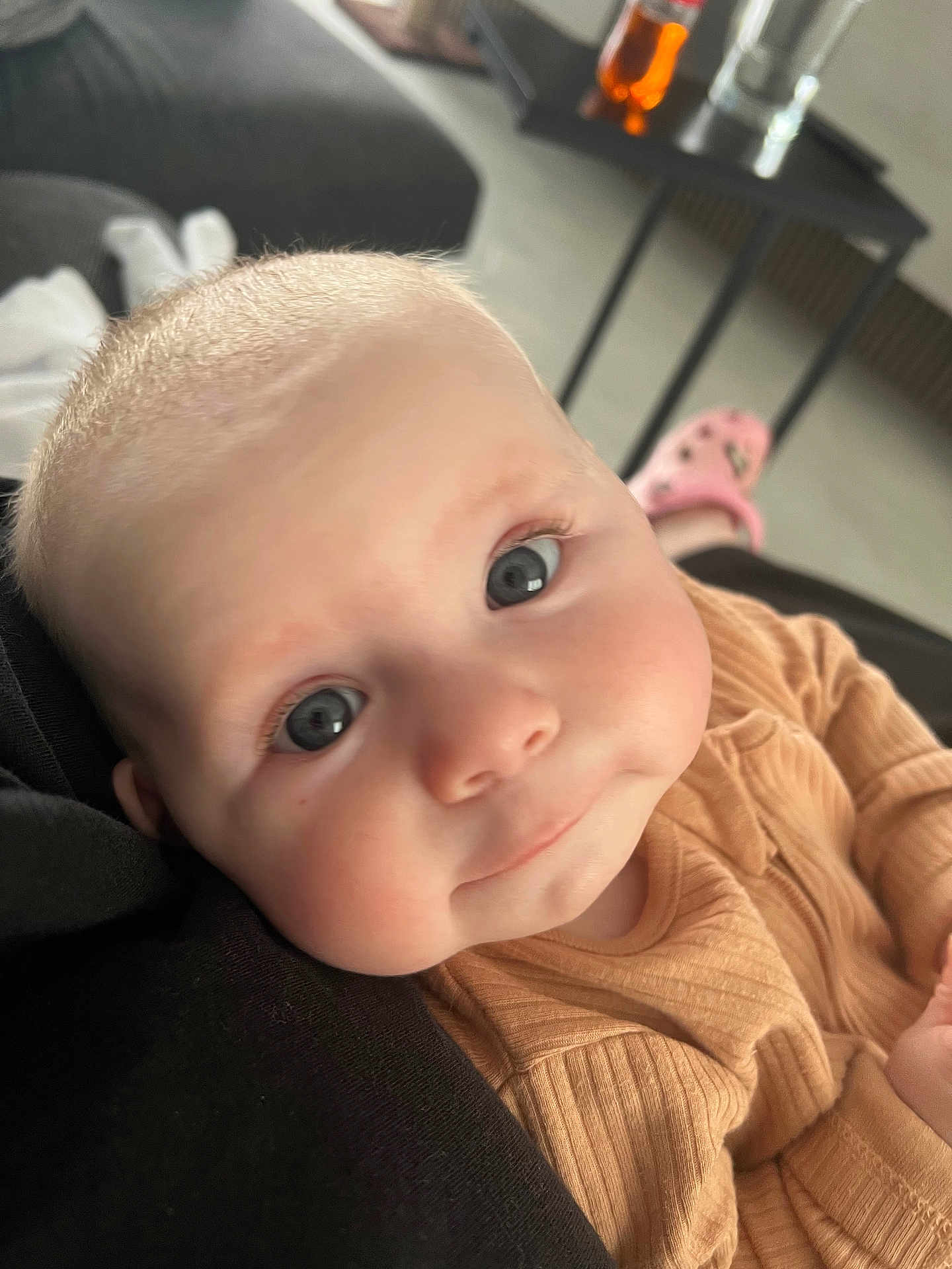 Blair joined the competition — help win amazing prizes! baby, child, face, blue_eyes, close_up, infant, cute, skin, clothing, ribbed, expression, indoor, furniture, blurred_background, person, head, smile, soft_light, human, cozy