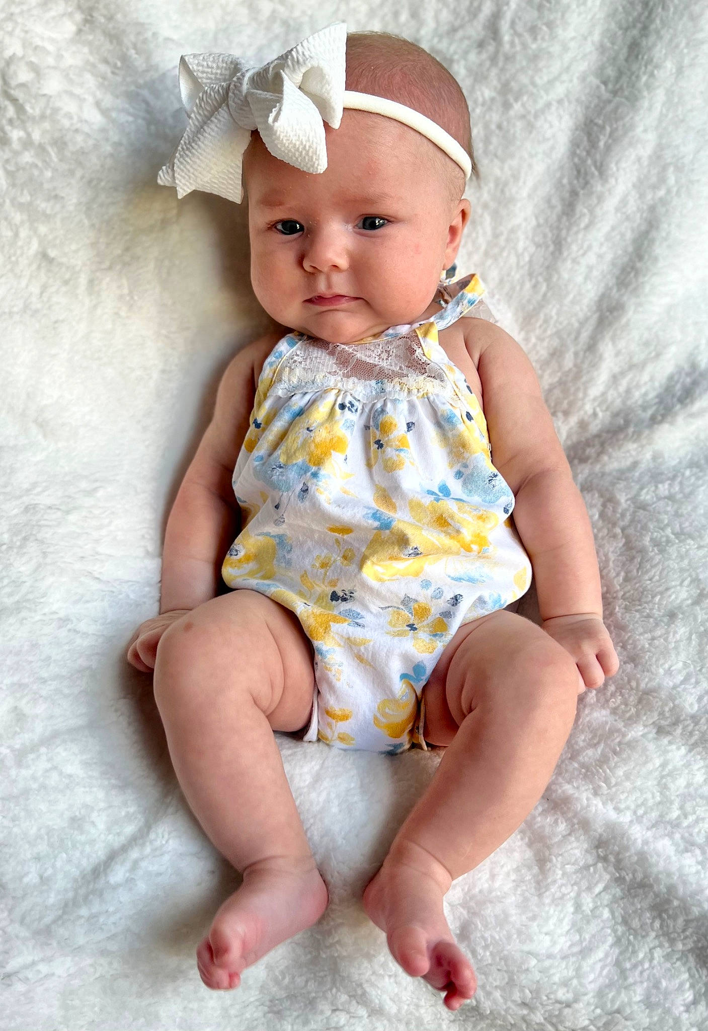 Charlotte is registered to the contest to win money with this photo: arm, baby, baby_toddler_clothing, cap, cheek, child, chin, dress, eye, face, hairstyle, head, headwear, human_body, iris, lip, person, pink, skin, sleeve