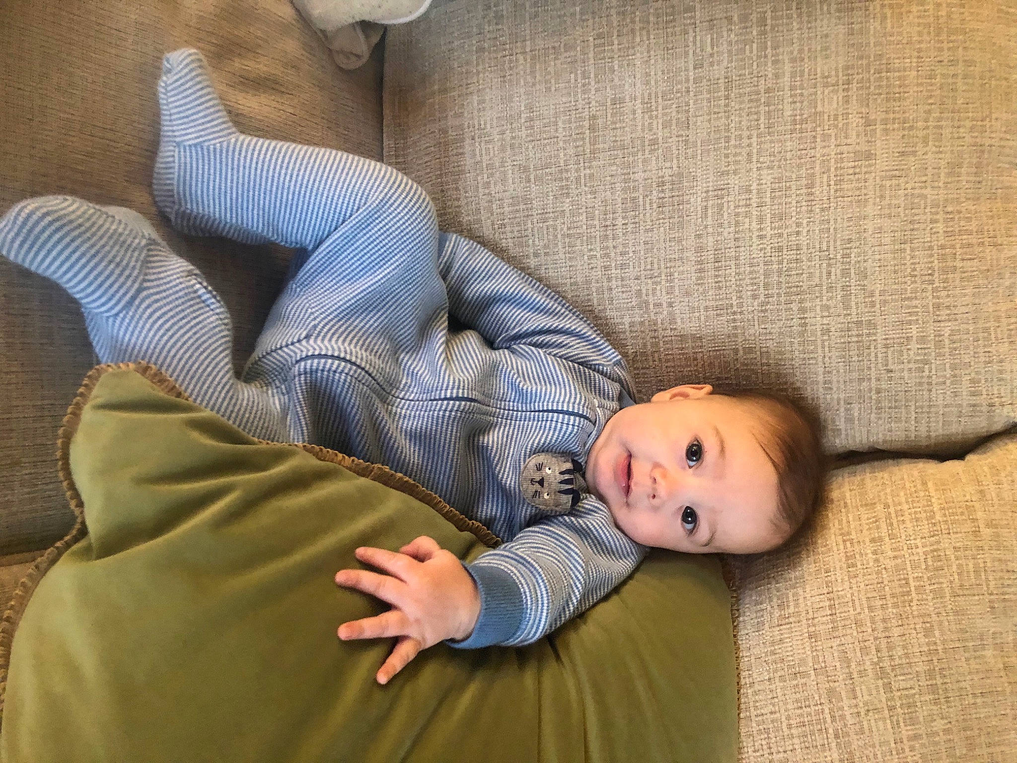 Griffin is registered to the contest to win money with this photo: baby, baby_toddler_clothing, bedtime, cheek, child, comfort, couch, elbow, grass, human_leg, lap, linens, nap, person, room, sitting, sleep, textile, thigh, toddler