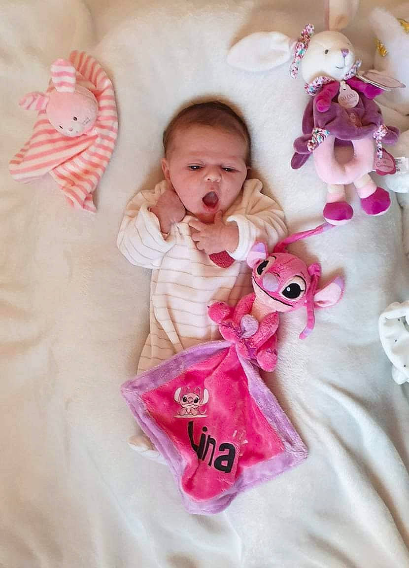 Lina participe au concours pour gagner de l'argent avec cette photo : baby, baby_products, baby_toddler_clothing, bedding, child, dress, fawn, happy, linens, magenta, outerwear, pattern, peach, person, pink, product, skin, sleeve, textile, toddler