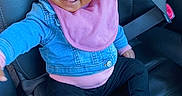 Emerie joined the competition — help win amazing prizes! baby, black_pants, car_interior, car_seat, child, cute, denim_jacket, footwear, happy, indoor, infant, person, pink_bib, pink_bow, portrait, reaching_out, seatbelt, smiling, sneakers, young_child