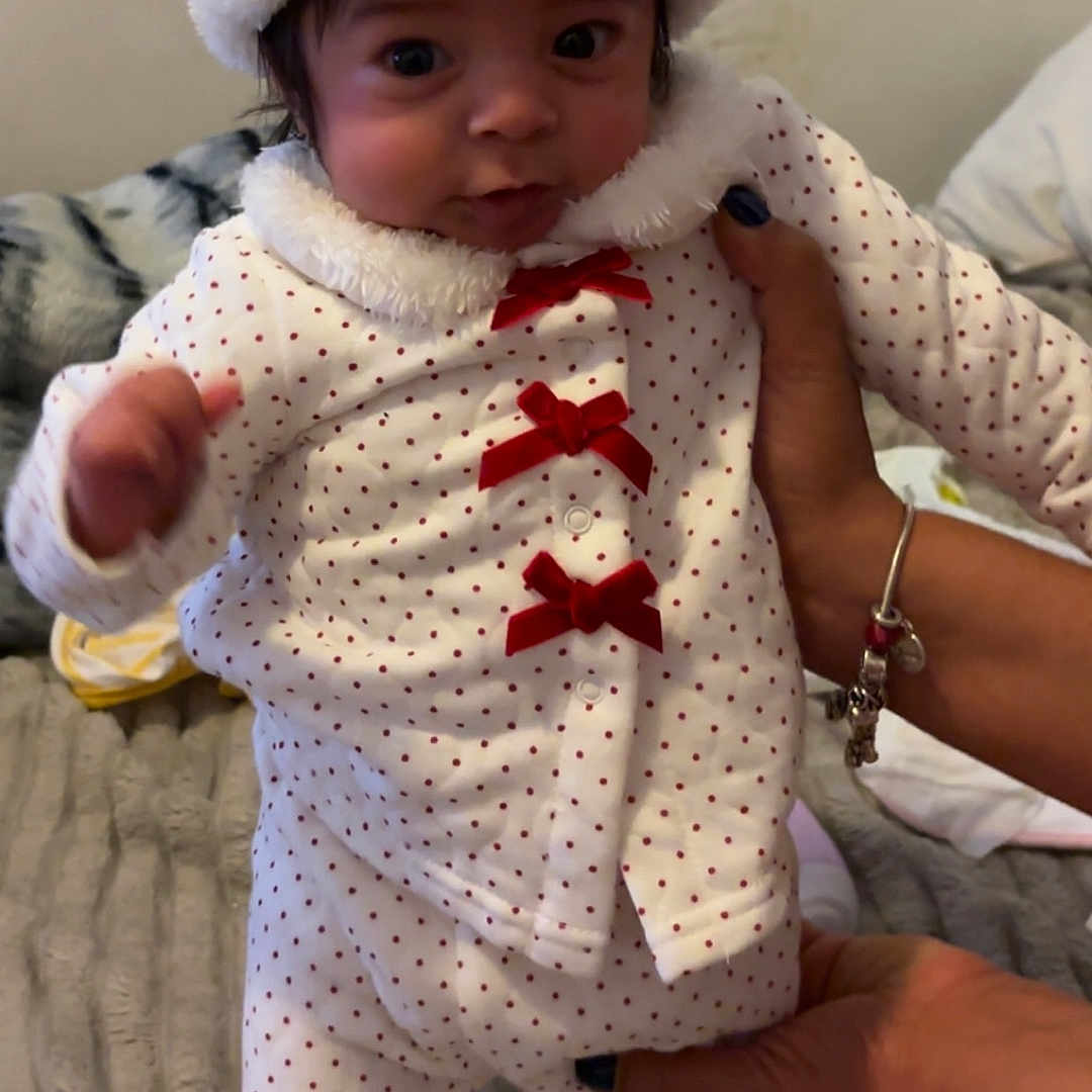 Ialany Melendez is registered to the contest to win money with this photo: baby, beanie, bodypart, bonnet, cap, clothing, couch, face, finger, furniture, hand, happy, hat, head, hood, knitwear, person, photography, portrait, sweater