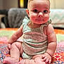 Britton is registered to the contest to win money with this photo: baby, child, infant, sitting, cute, face, skin, eyes, hands, legs, clothing, quilt, pattern, colorful, indoors, portrait, expression, soft, chubby, cute_face