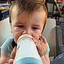 Emrys a rejoint le concours — aidez-le/la à gagner de superbes lots ! baby, bottle, milk, high_chair, drinking, face, child, indoor, people, blurry_background, table, chair, food, feeding, cute, person, young_child, messy, casual_clothing, daylight