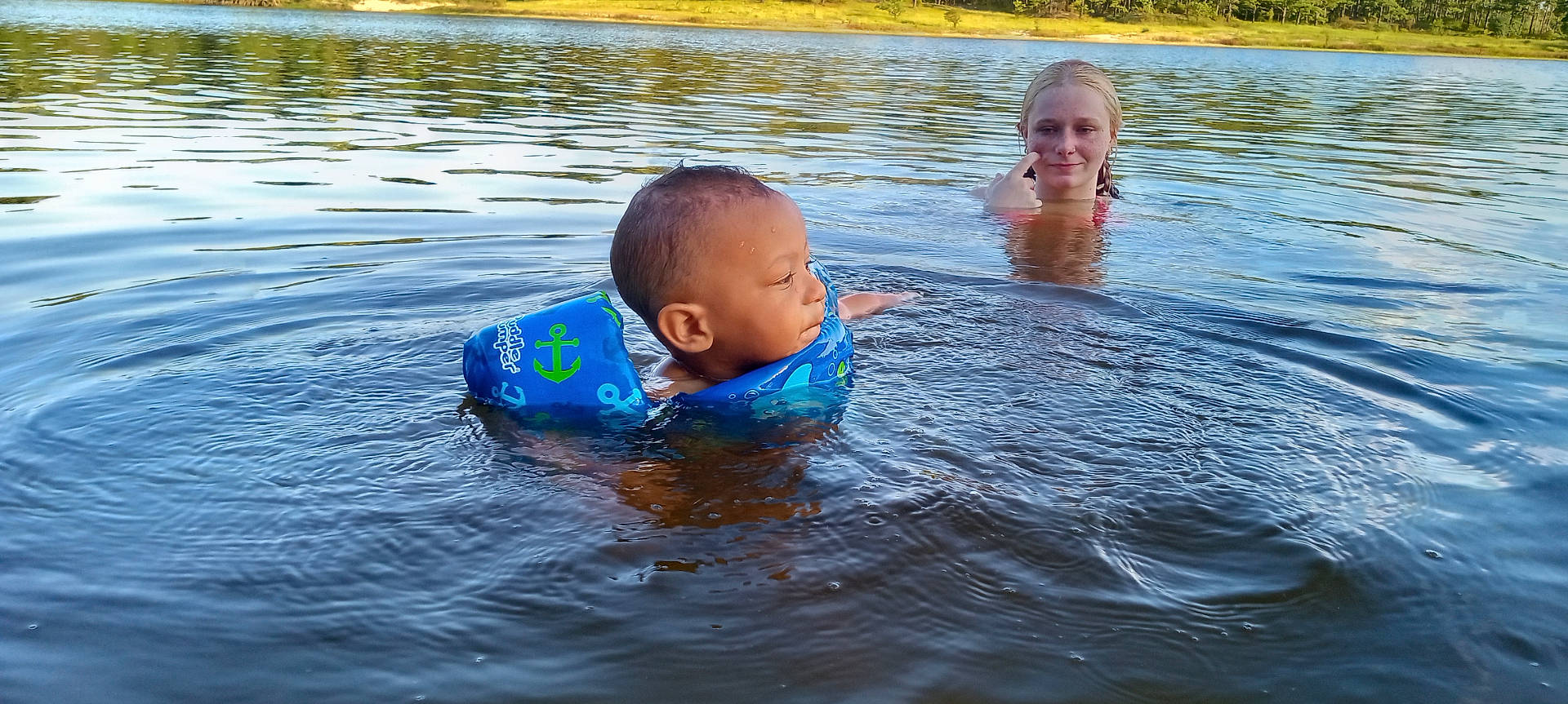 Zhyion Grant joined the competition — help win amazing prizes! baby, bathing, clothing, face, head, lake, leisureactivities, lifejacket, nature, outdoors, person, photography, pool, portrait, ripple, sport, swimming, vest, water, watersports