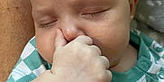 Mckenzie is registered to the contest to win money with this photo: baby, child, closeup, clothing, cute, face, green, hand, indoors, infant, pattern, peaceful, person, portrait, resting, skin, sleeping, soft, thumb, white