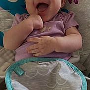 Mckenzie joined the competition — help win amazing prizes! baby, baby_bib, baby_seat, blue_fish, child, closeup, clothing, cute, face, hand, happy, indoor, infant, jellyfish, joyful, person, playful, purple_onesie, seat, smiling