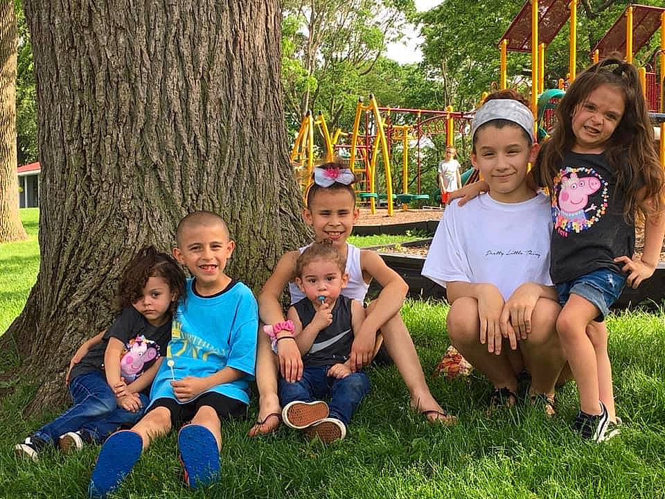 Adelynn is registered to the contest to win money with this photo: child, cousin, family, fun, grass, happy, joy, leisure, people, person, plant, play, sibling, sitting, smile, social_group, spring, style, summer, tree