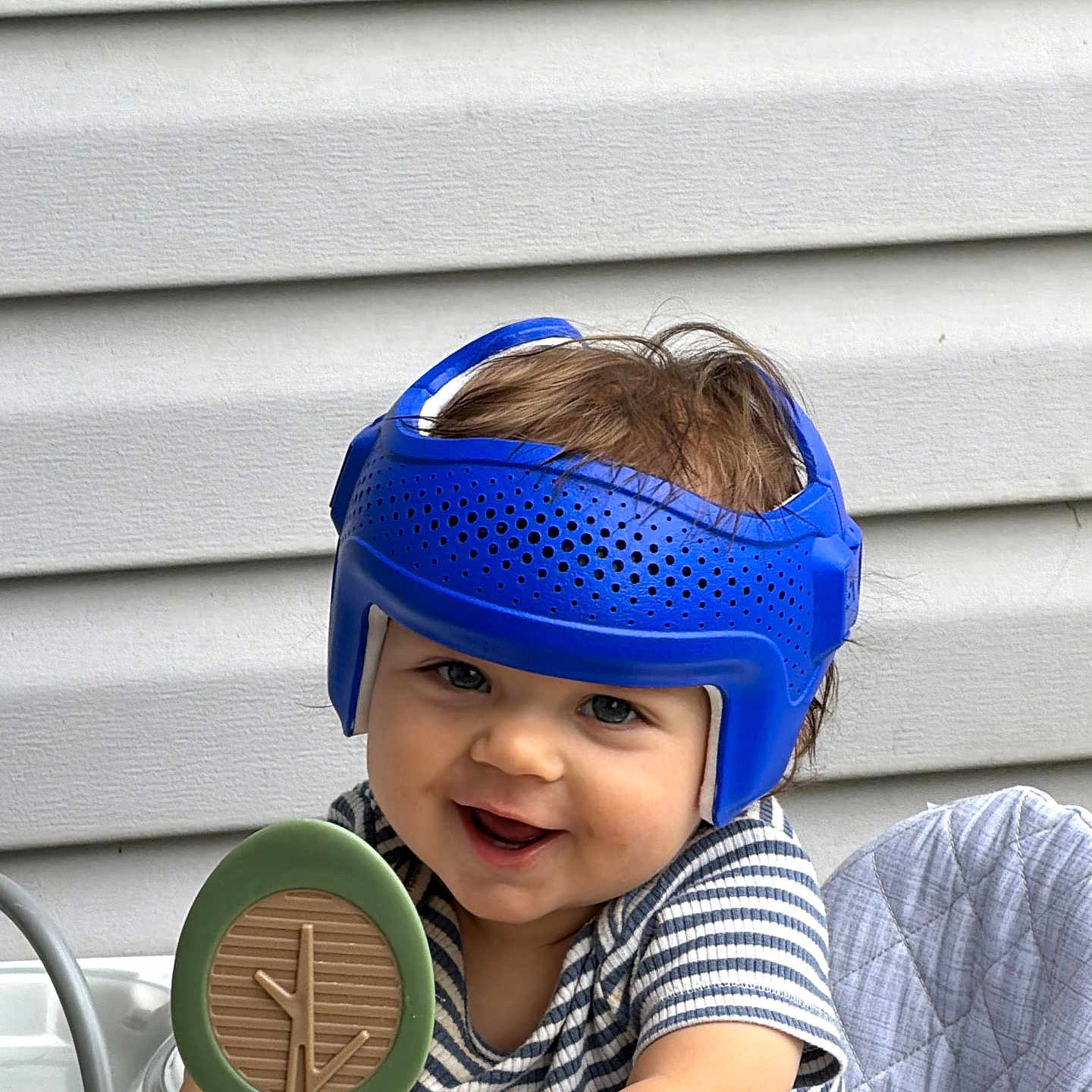 Leonard joined the competition — help win amazing prizes! baby, child, helmet, blue_helmet, smile, happy, toy, tree_toy, high_chair, striped_shirt, indoor, person, face, cute, playful, young_child, infant, headgear, sitting, background