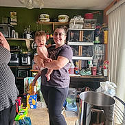 Leonard joined the competition — help win amazing prizes! baby, woman, kitchen, indoor, smile, person, holding, appliances, pots, shelves, storage, food, clothing, glasses, floor, light, window, vertical_blinds, container, happy