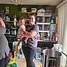 Leonard joined the competition — help win amazing prizes! baby, woman, kitchen, indoor, smile, person, holding, appliances, pots, shelves, storage, food, clothing, glasses, floor, light, window, vertical_blinds, container, happy
