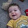 Leonard joined the competition — help win amazing prizes! baby, child, smiling, yellow_shirt, teddy_bear, carpet, indoor, happy, portrait, cute, infant, person, face, clothing, toy, young_child, head, expression, closeup, lying_down