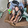 Leonard is registered to the contest to win money with this photo: baby, car_seat, child, smile, toy, turtle, blanket, couch, furniture, indoor, person, seat_belt, carrying_handle, plush, room, happy, foot, head, clothing, sitting