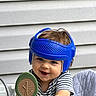 Leonard joined the competition — help win amazing prizes! baby, child, helmet, blue_helmet, smiling, toy, tree_toy, high_chair, striped_shirt, indoor, face, happy, playful, person, seat, brown_hair, cute, infant, protective_gear, background_wall