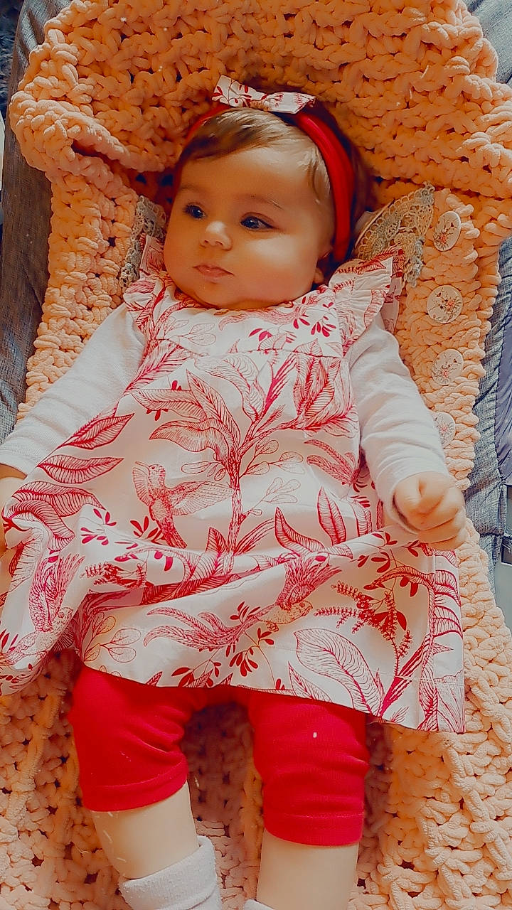 Allya participe au concours pour gagner de l'argent avec cette photo : baby, baby_toddler_clothing, cheek, child, chin, dress, eye, face, head, iris, linens, lip, nose, orange, outerwear, peach, person, pink, skin, sleeve