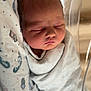 Tucker is registered to the contest to win money with this photo: newborn, baby, sleeping, swaddled, blanket, hospital, bassinet, infant, peaceful, face, skin, head, resting, closeup, soft, newborn_baby, child, person, indoors, light