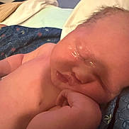 Tucker is registered to the contest to win money with this photo: baby, sleeping, close_up, infant, hand, blanket, indoor, skin, face, newborn, resting, peaceful, child, cute, soft, young, person, comfort, toddler, portrait