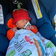 Tucker is registered to the contest to win money with this photo: newborn, baby, car_seat, blanket, knitted_hat, pacifier, sleeping, orange_clothing, blue_car_seat, infant, cozy, cute, child, face, headwear, indoor, resting, baby_accessory, child_seat, closeup