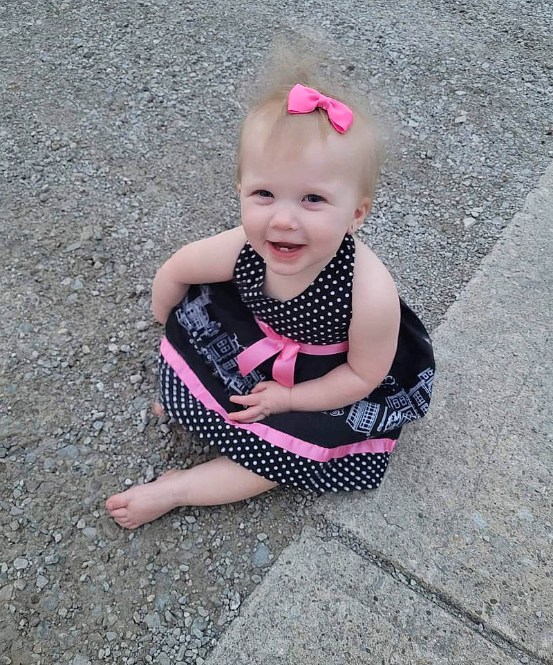 Everly joined the competition — help win amazing prizes! asphalt, baby, baby_toddler_clothing, child, dress, eye, fashion_accessory, foot, fun, grass, hairstyle, happy, head, human_body, human_leg, magenta, pattern, person, road_surface, smile