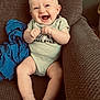 Bryson is registered to the contest to win money with this photo: baby, smiling, infant, couch, clothing, onesie, happy, sitting, face, barefoot, indoor, child, blue_cloth, texture, skin, person, cute, young, comfortable, joyful