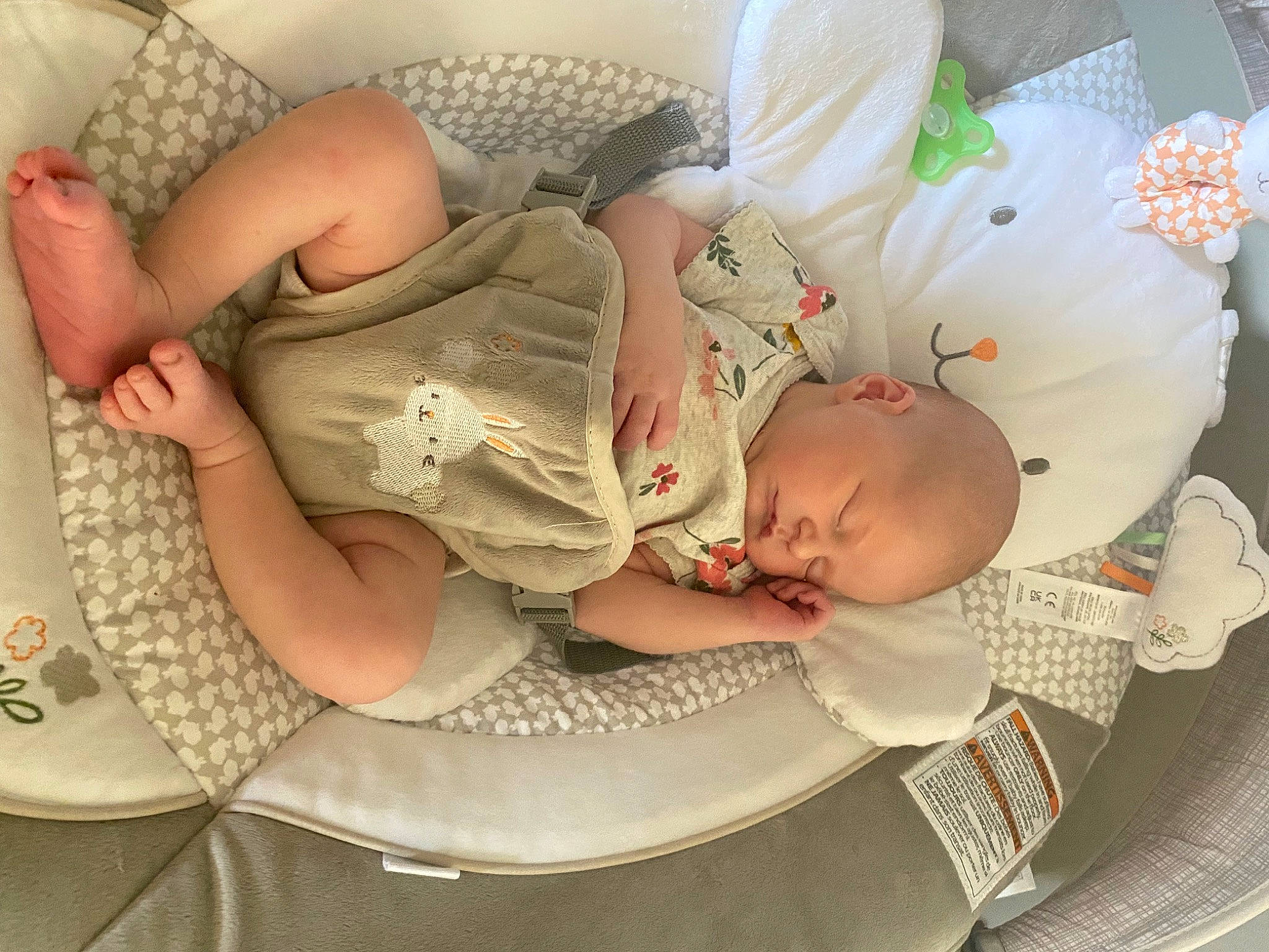 Zoey is registered to the contest to win money with this photo: arm, baby, baby_products, baby_sleeping, baby_toddler_clothing, cheek, chest, child, comfort, fashion_accessory, finger, hand, headgear, nail, pattern, person, sitting, skin, sleeve, thigh