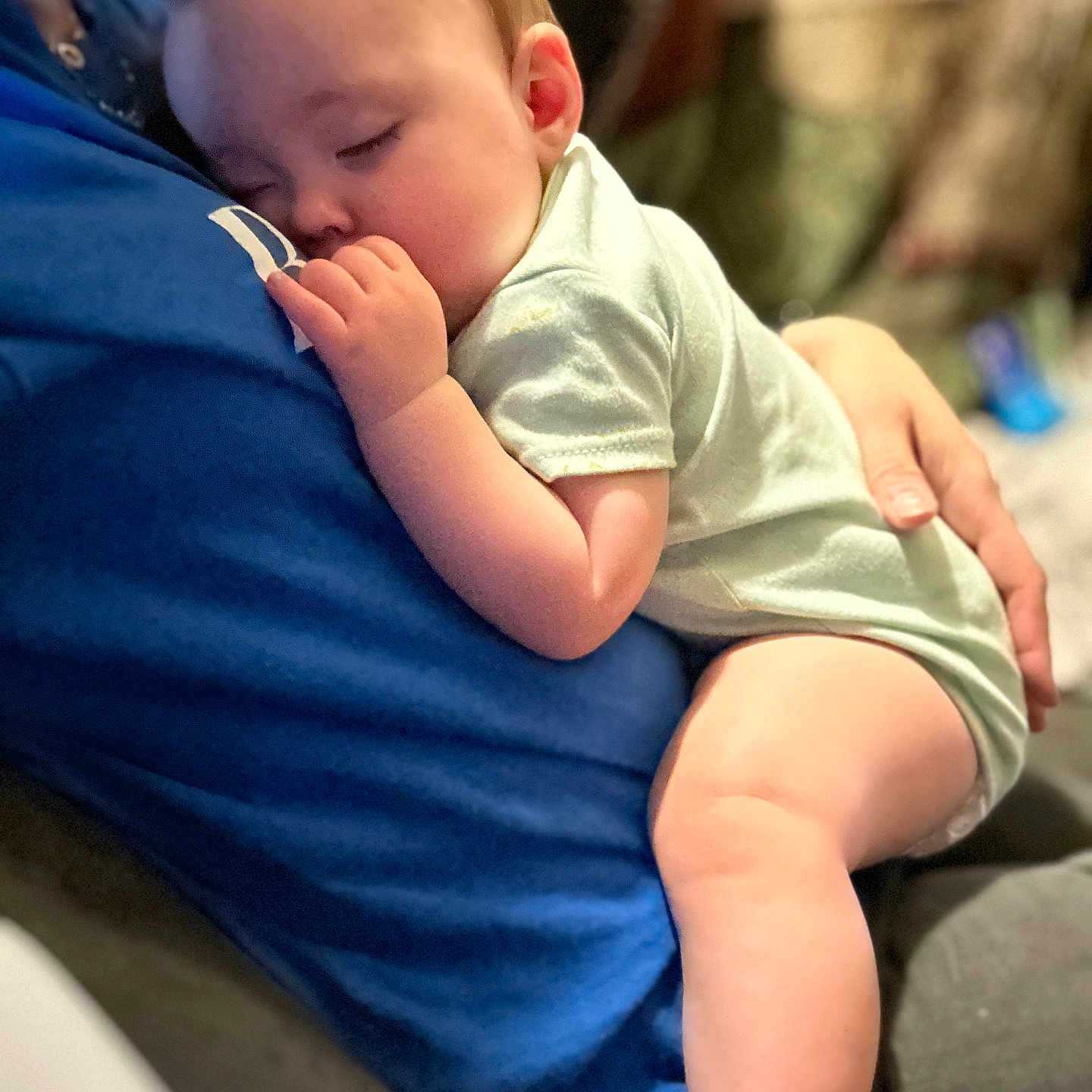 Izabella is registered to the contest to win money with this photo: baby, blue_shirt, child, closeup, comfort, cozy, cuddle, face, hand, indoor, infant, legs, love, nap, peaceful, person, rest, skin, sleeping, toddler
