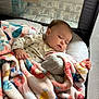 baby, sleeping, blanket, plush_toy, playpen, mesh, cozy, infant, child, resting, soft_toy, colorful, nap, cute, peaceful, indoors, comfort, fabric, clothing, person