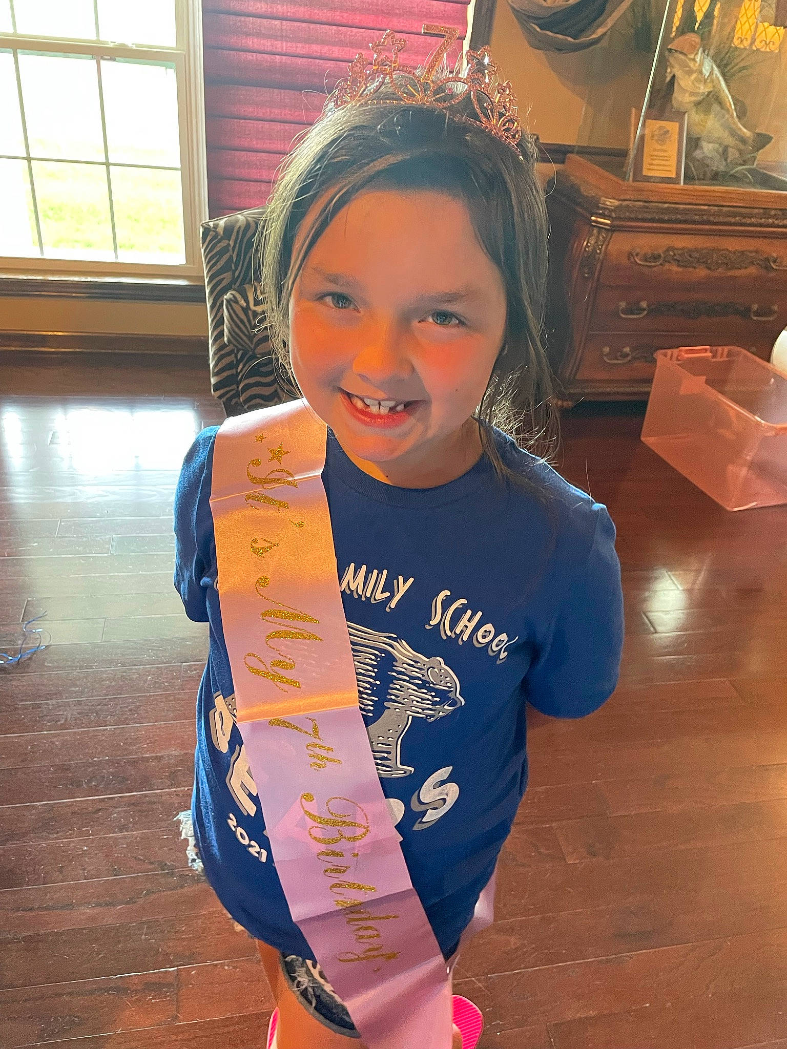 Jaylee joined the competition — help win amazing prizes! floor, flooring, happy, hardwood, headwear, joy, leisure, long_hair, neck, orange, person, shoulder, skin, sleeve, smile, sportswear, standing, t_shirt, thigh, toddler